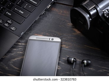 Wooden background with gadgets - Shutterstock ID 323810783