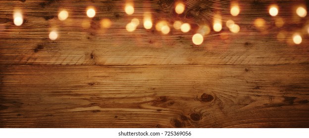 Wooden background with golden light effects for a christmas decoration