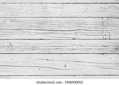 Wooden background. Old black and white painted fence in good condition. Solid wooden wall from weathered cracked boards. Barn wood wall.