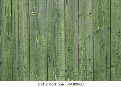 Wooden background. Old green painted fence in good condition. Solid wooden wall from weathered cracked boards.  Grunge St. Patrick`s day background.
