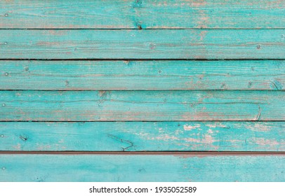 Wooden background, old wooden wall, painted blue, with slits and nails.