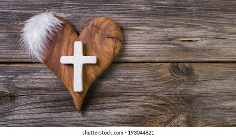 Wooden Background With Olive Heart And White Cross For An Obituary Notice.