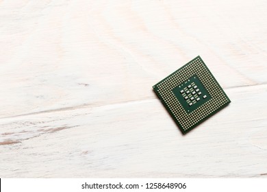 wooden background on it is a processor for microchips. close-up. view from above.