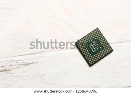 wooden background on it is a processor for microchips. close-up. view from above.