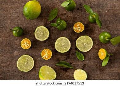 Wooden Background Sliced  Kumquat And Leaf