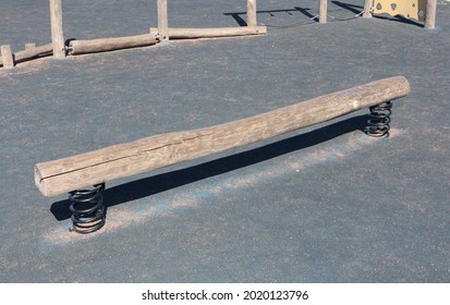 Wooden Balance Beam With The Bows In The Playground.