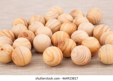 Wooden balls on beige fabric background.