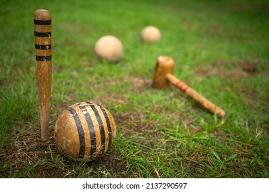 Wooden balls for playing croquet. Croquet balls on a field with green grass.