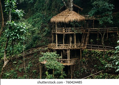 Wooden bamboo hovel house in forest. Film color toned filter
