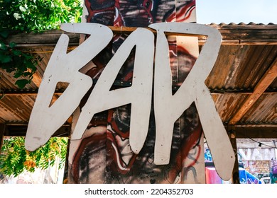 Wooden 'bar' Sign On An Industrial Site. Homemade Sign In Modern Writing In A Graffiti Bar. 