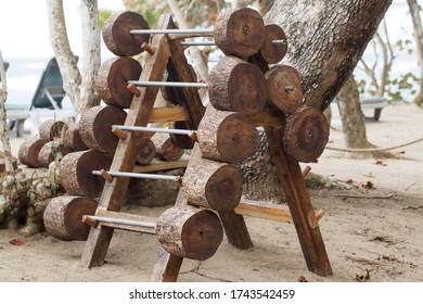 Wooden Barbbells On The Beach. Outdoor Gym.