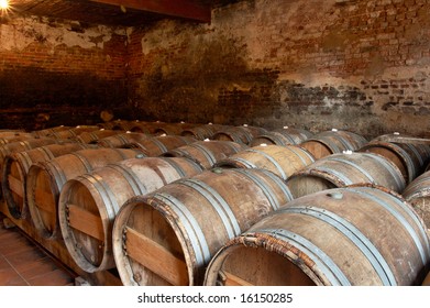 Wooden barrels in a wine cellar in a winery