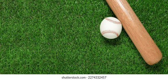 Wooden baseball bat and ball on green grass, flat lay. Sports equipment - Powered by Shutterstock