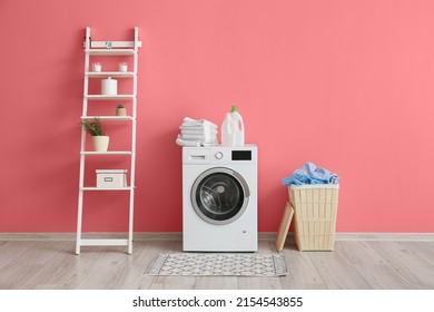 Wooden basket with laundry, washing machine and shelving unit near pink wall - Shutterstock ID 2154543855