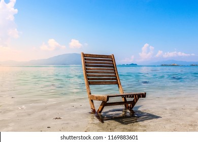 Wooden Beach Chair Empty Ocean Shore Landscape Vacation Relaxation Peace - Powered by Shutterstock