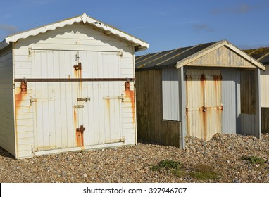 Wooden beach huts on shingle beach at Lancing, Near Brighton, West Sussex, England - Shutterstock ID 397946707