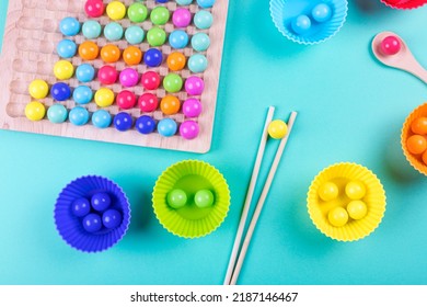 Wooden Beads Board Game On Blue Background. New Anti-stress And Thinking Logic Toys For Children And Adult. Flat Lay. 