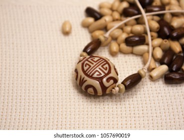 Wooden Beads On The Aida Fabric Background