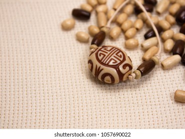 Wooden Beads On The Aida Fabric Background