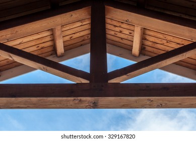 Wooden Beam Ceiling With Symmetrical Design. Modern Art And Design. Interior Design With Wood Detail. Abstract Minimal Art. Blue Sky Background. Artistic Design. Geometrical Balance And Design.