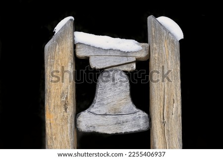 Wooden bell isolated in black background.