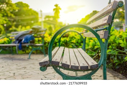 Wooden bench with blur background with copy space. low angle view of a bench in a park, low angle view of a lonely bench in the park with out of focus background