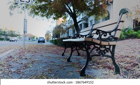 A Wooden Bench At A Bust Stop