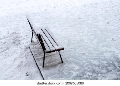Wooden bench at the entrance in the snow of the house. - Shutterstock ID 2009605088