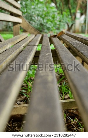 Wooden bench in the garden, close up shot, selective focus