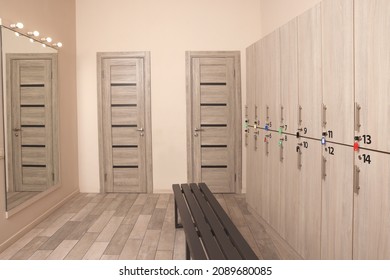 Wooden Bench, Mirror And Lockers In Changing Room Interior