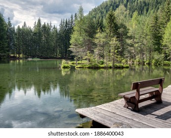 Wooden bench and nice view over Lake Winkelbergsee near Laengenfeld, Tyrol, Austria - Powered by Shutterstock