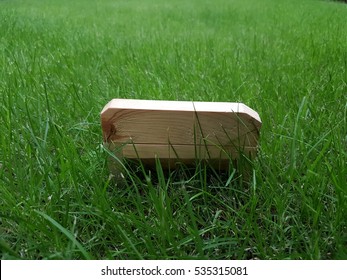 Wooden bench on fresh green grass field used for background and design