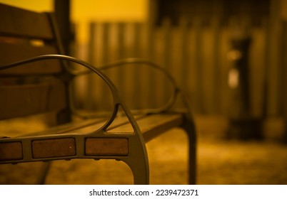 Wooden bench on park at night - Powered by Shutterstock