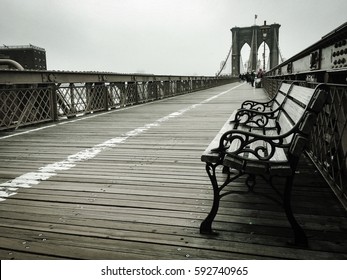 Wooden Bench On The Walkway At Brooklyn Bridge And The Fog In Vintage Monochrome Style