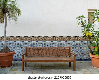 Wooden bench in the park against the wall. Carved bench. - Shutterstock ID 2189025885