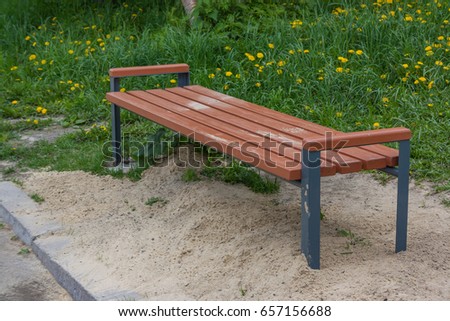 A wooden bench in the park a summer sunny day