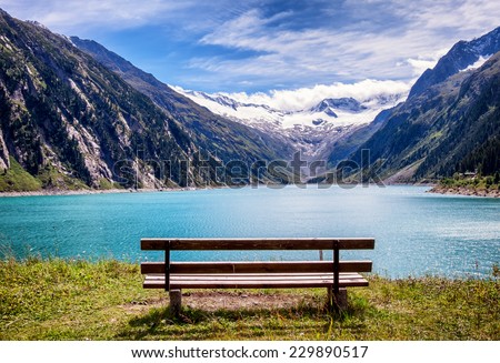 wooden bench at a reservoir in austria