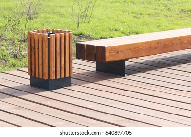 Wooden Bench And Trash Can In The Park