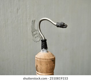 Wooden bird cage metal stainless hook or hanger part isolated on horizontal gray wall background. - Powered by Shutterstock