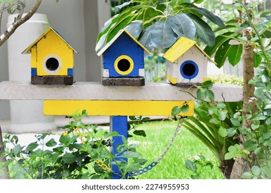 Wooden birdhouses decorating the garden on a sunny day