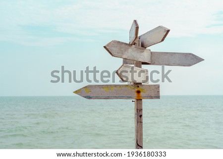 Wooden blank sign white color with sea and blue sky.