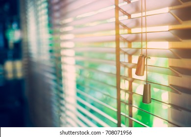 Wooden blinds with sun rays. Vintage color style.