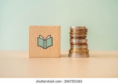 A wooden block with a book icon and coins.