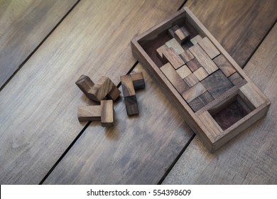 Wooden Block Brain Teaser Puzzle On Wood Background Top View