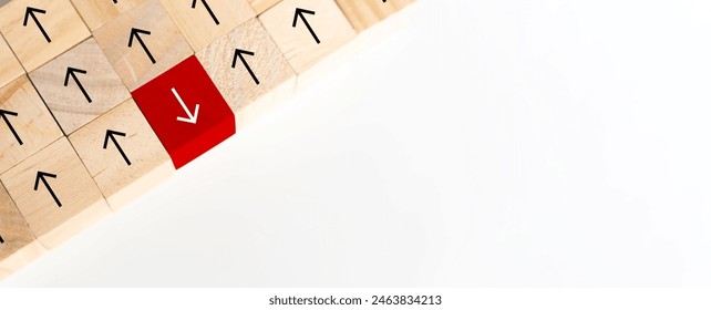 Wooden block cube reversing perspective direction arrow up opposite way thinking leadership on white table background. Mind changing sign symbol problem solving decision making concept.