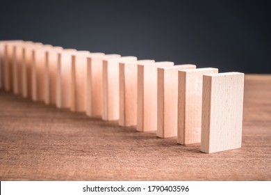 Wooden Block Domino Standing Stable On Wood Table, Business Chain And Connection Symbol, Domino Effect Theory