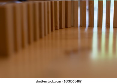 Wooden Block Domino Standing Stable On Wood Table, Business Chain And Connection Symbol, Domino Effect Theory