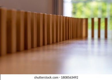 Wooden Block Domino Standing Stable On Wood Table, Business Chain And Connection Symbol, Domino Effect Theory