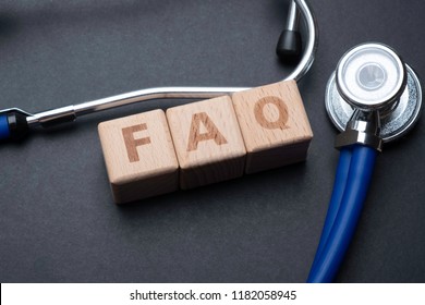 Wooden Block Form The Word FAQ With Stethoscope. Medical Concept.