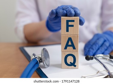 Wooden Block Form The Word FAQ With Stethoscope. Medical Concept.